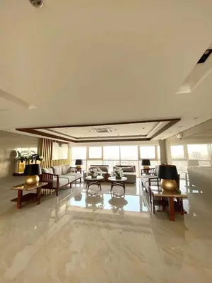 a living room with tables and chairs in a building at Condo next door in Manila