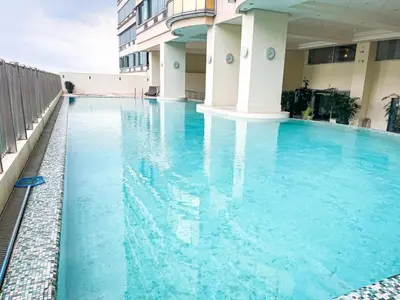 a swimming pool in a building with blue water at Stunning & Luxury 4BR in Manila Bay White Beach in Manila