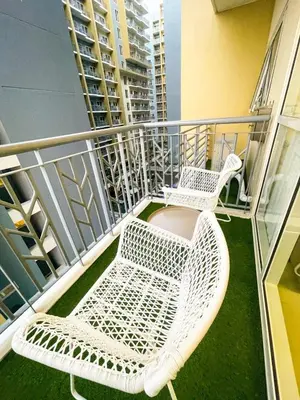 two white chairs sitting on a balcony at Cozy 3BR in Manila Bay near Okada II 12pax in Manila