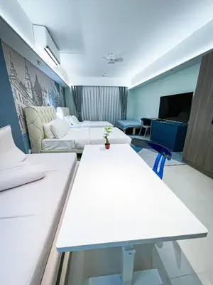 a hotel room with two beds and a couch at Lovely Penthouse across City of Dreams, Airport in Manila