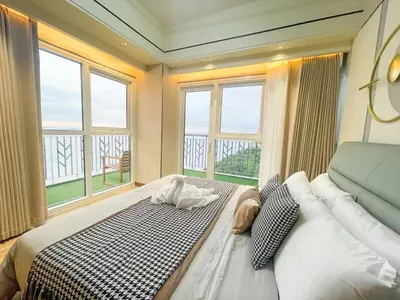 a bedroom with a large bed with a large window at Luxurious 2BR with Manila Bay Sunset II 6pax in Manila