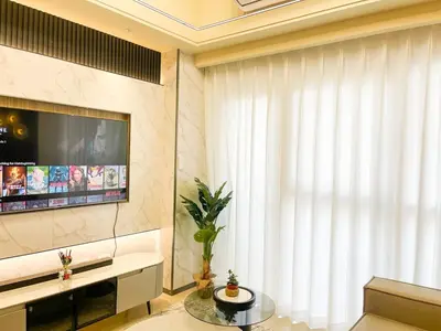 a living room with a tv and a large window at Luxurious 2BR with Manila Bay Sunset II 6pax in Manila