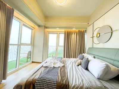 a bedroom with a large bed and a large window at Luxurious 2BR with Manila Bay Sunset II 6pax in Manila