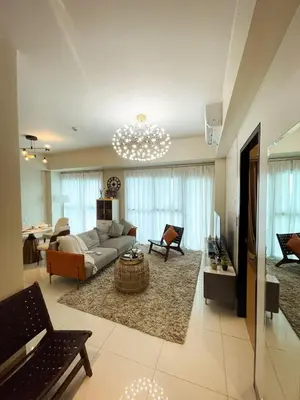 a living room with a couch and a table at Lovely & Modern 1BR in Manila across Okada in Manila