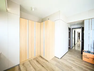 a room with white walls and wooden wardrobes at Luxury 2BR beside Okada Manila in Manila