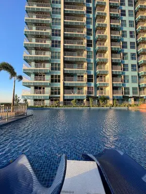 a swimming pool in front of some tall buildings at Luxury 2BR beside Okada Manila in Manila