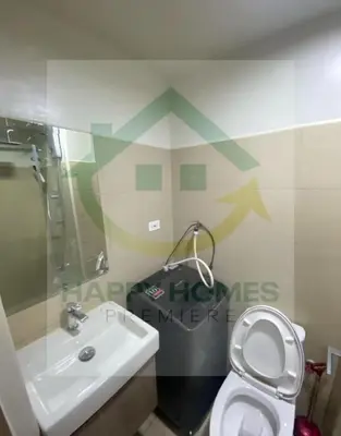 a bathroom with a white toilet and a sink at Serene Suite at Shore 3 in Manila
