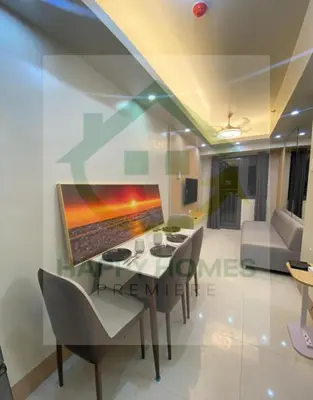 a dining room with a table and chairs at Serene Suite at Shore 3 in Manila