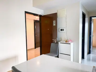 a kitchen with a table and a chair in a room at Luxury 2BR Corner near Solaire & Okada II Sunset in Manila