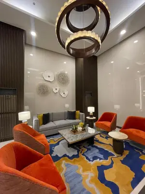 a living room with orange furniture and a large rug at Luxury 2BR Corner near Solaire & Okada II Sunset in Manila