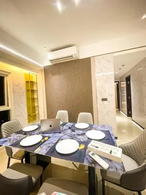 a dining room with a table with a laptop on it at Modern 2BR beside Okada Manila with Sunset View in Manila