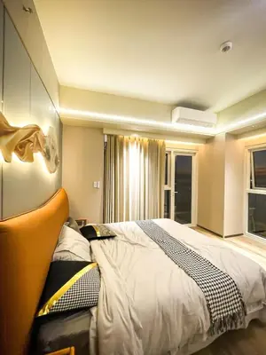 a bedroom with a large bed and a window at Modern 2BR beside Okada Manila with Sunset View in Manila