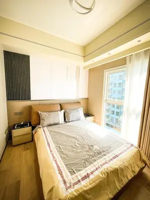 a bedroom with a large bed with a large window at Modern 2BR beside Okada Manila with Sunset View in Manila