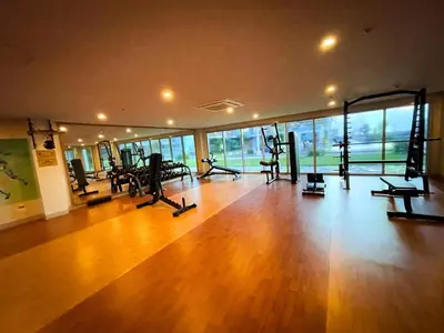 a gym with treadmills and machines in a room at Luxurious 1BR in Bayshore w Sunset View near Okada in Manila