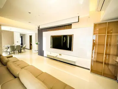 a living room with a couch and a tv on a wall at Luxurious 3BR in Manila Bay across Okada II 12pax in Manila