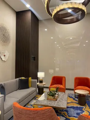 a living room with a couch and orange chairs at Luxurious 3BR in Manila Bay across Okada II 12pax in Manila