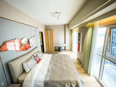 a bedroom with a bed and a wall with a helmet on it at Luxurious 3BR in Manila Bay across Okada II 12pax in Manila