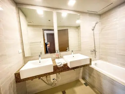 a bathroom with two sinks and a mirror and a tub at Luxurious 3BR in Manila Bay across Okada II 12pax in Manila
