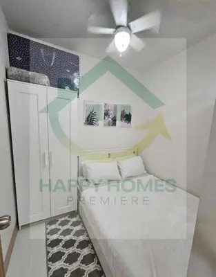 a room with a bed and a ceiling fan at New Crib at Shore 3 in Manila