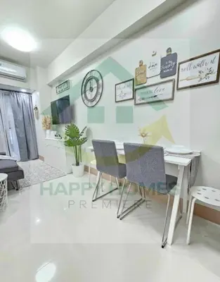 a living room with a table and chairs at New Crib at Shore 3 in Manila