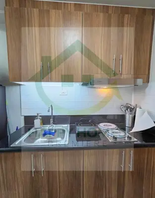 a kitchen with a sink and a counter top at New Crib at Shore 3 in Manila