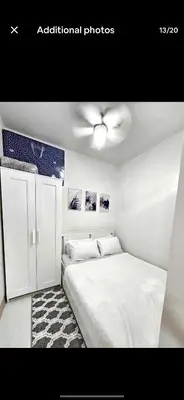 a bedroom with a bed and a ceiling fan at New Crib at Shore 3 in Manila