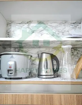 a kitchen counter with a appliance on a shelf at New Crib at Shore 3 in Manila