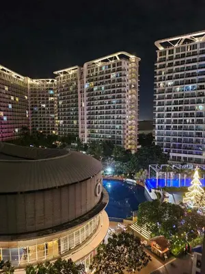 a view of a city at night with tall buildings at One Bedroom at Azure Urban Near Airport in Manila