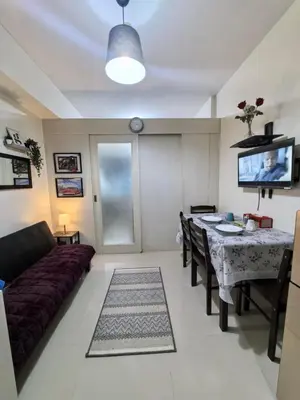 a living room with a couch and a table at Sea Residences by Sonny in Manila