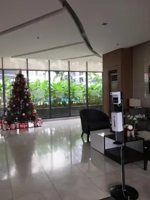 a christmas tree in the middle of a room at Owls Nest Staycation in Manila