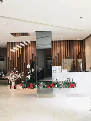 a lobby of a hotel with flowers in the middle at Owls Nest Staycation in Manila