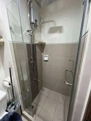 a shower with a glass door in a bathroom at Owls Nest Staycation in Manila