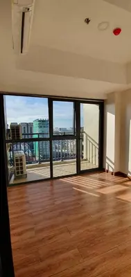 an empty living room with a view of a building at Manila Airport Accommodation at NAIA road in Manila