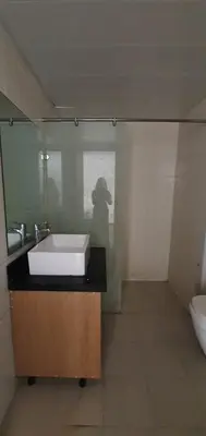 a bathroom with a sink and a toilet at Manila Airport Accommodation at NAIA road in Manila