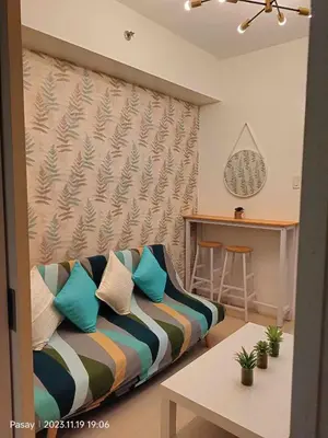 a living room with a couch and a table at Gab's Crib - Staycation near Mall of Asia in Manila