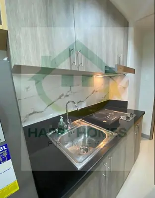 a kitchen with a sink and a counter top at Happy Sunshine at S Residences in Manila