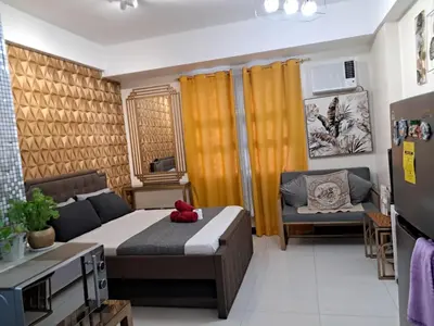 a small bedroom with a bed and a couch at 101 Newport Blvd Condotel, Manila -Hyuna Place, Across NAIA T3 in Manila