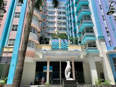a large building with a statue in front of it at 101 Newport Blvd Condotel, Manila -Hyuna Place, Across NAIA T3 in Manila