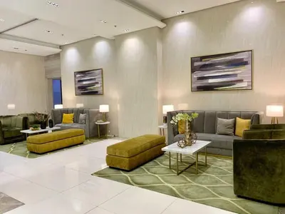 a living room with couches and a couch and tables at 101 Newport Blvd Condotel, Manila -Hyuna Place, Across NAIA T3 in Manila