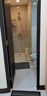 a bathroom with a shower and a toilet at 101 Newport Blvd Condotel, Manila -Hyuna Place, Across NAIA T3 in Manila