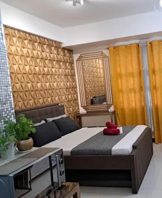a bedroom with a bed with a red stuffed animal on it at 101 Newport Blvd Condotel, Manila -Hyuna Place, Across NAIA T3 in Manila