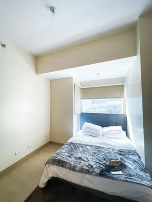 a bedroom with a large bed with a window at Stunning 2BR across Okada Manila with Sunset View in Manila