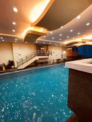 a large swimming pool in a hotel room at Birch Tower Condominium Malate Manila by T&T in Manila