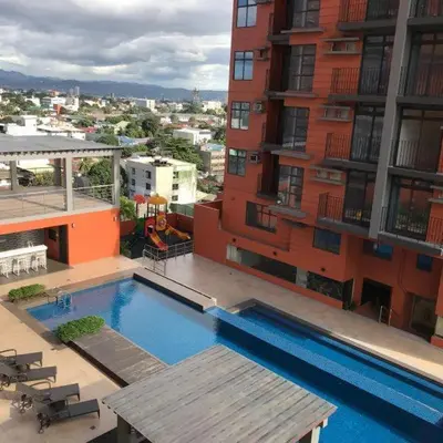 a swimming pool on top of a building at Portovita North Tower 10A, 10C in Manila