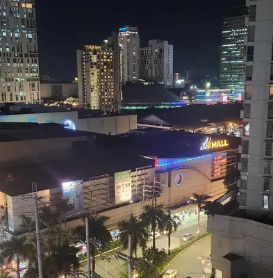 a view of a city at night with buildings at Portovita North Tower 10A, 10C in Manila