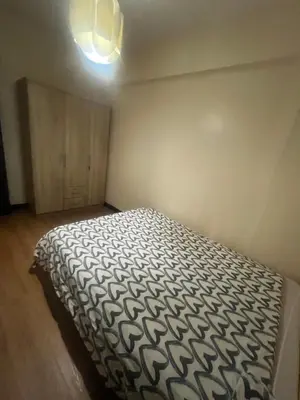 a bedroom with a bed and a light on the ceiling at Arista Place Condo 2 bedroom unit in Manila