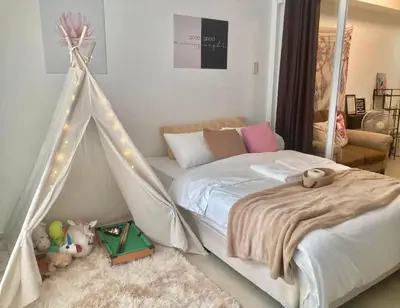 a bedroom with a bed with a tent at Sole Sisters Staycation in Manila