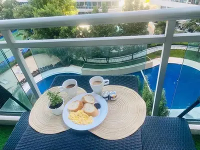 a plate of breakfast food on a table on a balcony at Sole Sisters Staycation in Manila