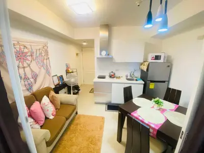 a small living room with a couch and a table at Sole Sisters Staycation in Manila