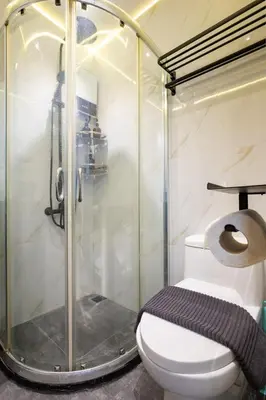 a bathroom with a shower and a white toilet at Yūgen 幽玄 Makati Home - Malls, Little Tokyo, Pool in Manila